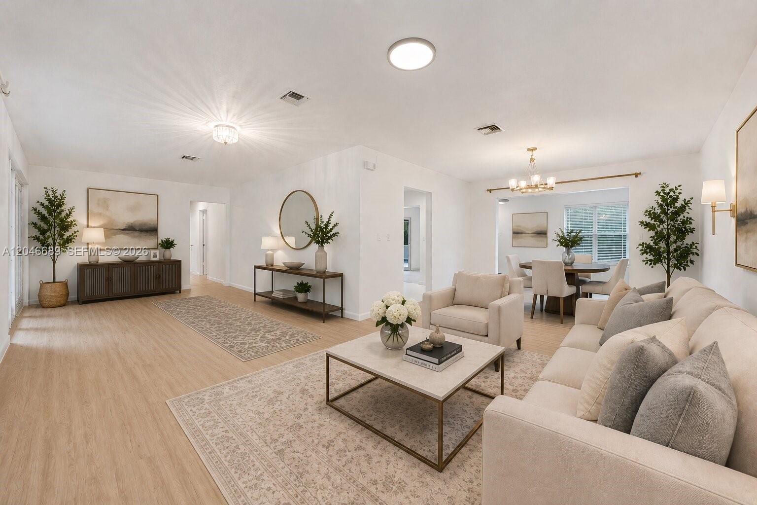 A bright, open-concept living and dining area features light wood flooring and neutral furniture — 7982 SW 89th St # 7982, Miami FL 33156, MIAMI, FL