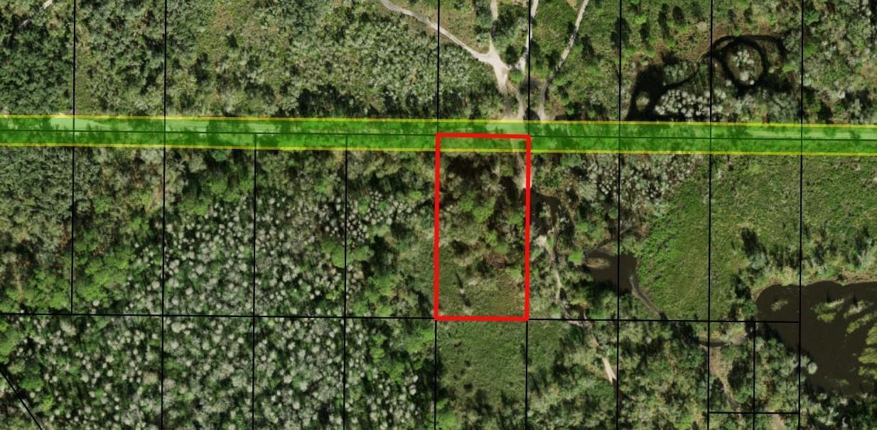 An aerial map view shows a rectangular property lot outlined in red along a road — 0 County Rd 54, FL 33849, FL