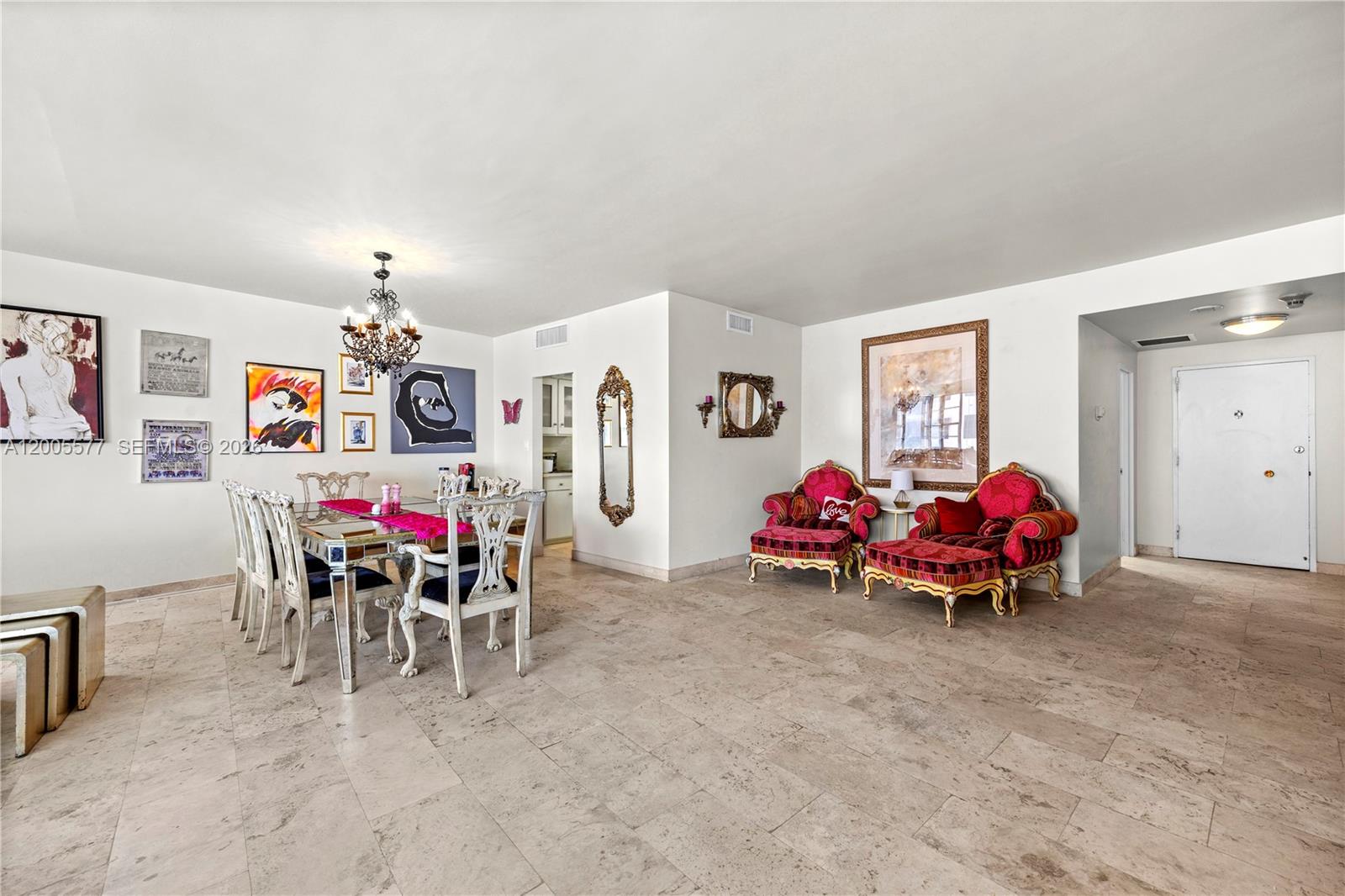 A dining area and seating space feature tile floors, ornate furniture, and various wall art — 5255 Collins Ave # 11A, Miami Beach FL 33140, MIAMI BEACH, FL