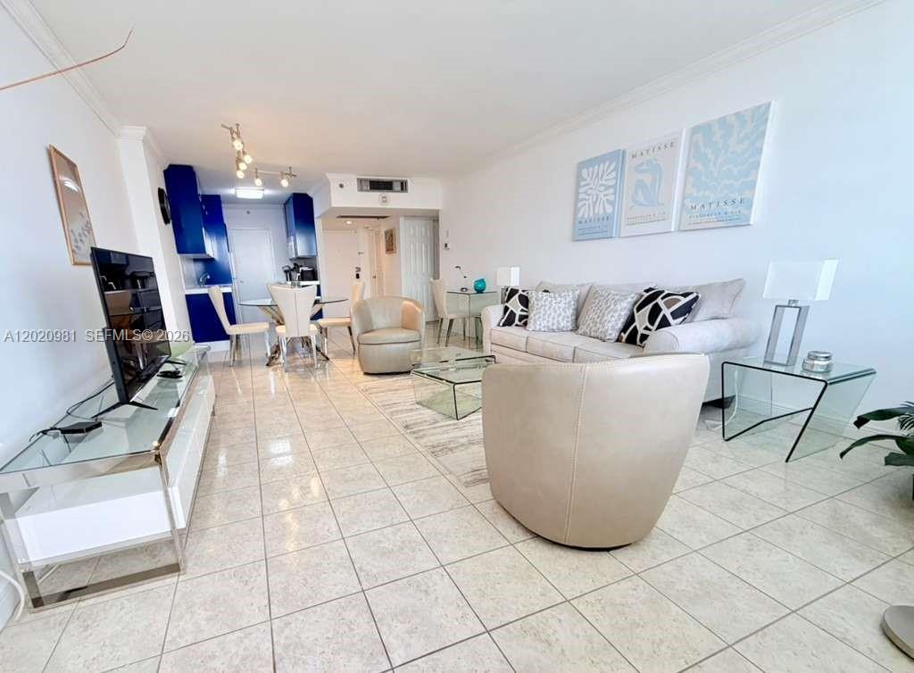 A living room features light-colored tile floors, a beige sofa, and a glass coffee table — 100 Lincoln Rd # 1423, Miami Beach FL 33139, MIAMI BEACH, FL