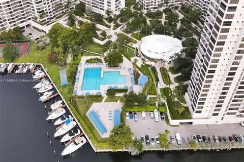 An aerial view shows a residential complex with a swimming pool, marina, and parking lot — 2500 Parkview Drive # 814, Hallandale Beach FL 33009, HALLANDALE BEACH, FL