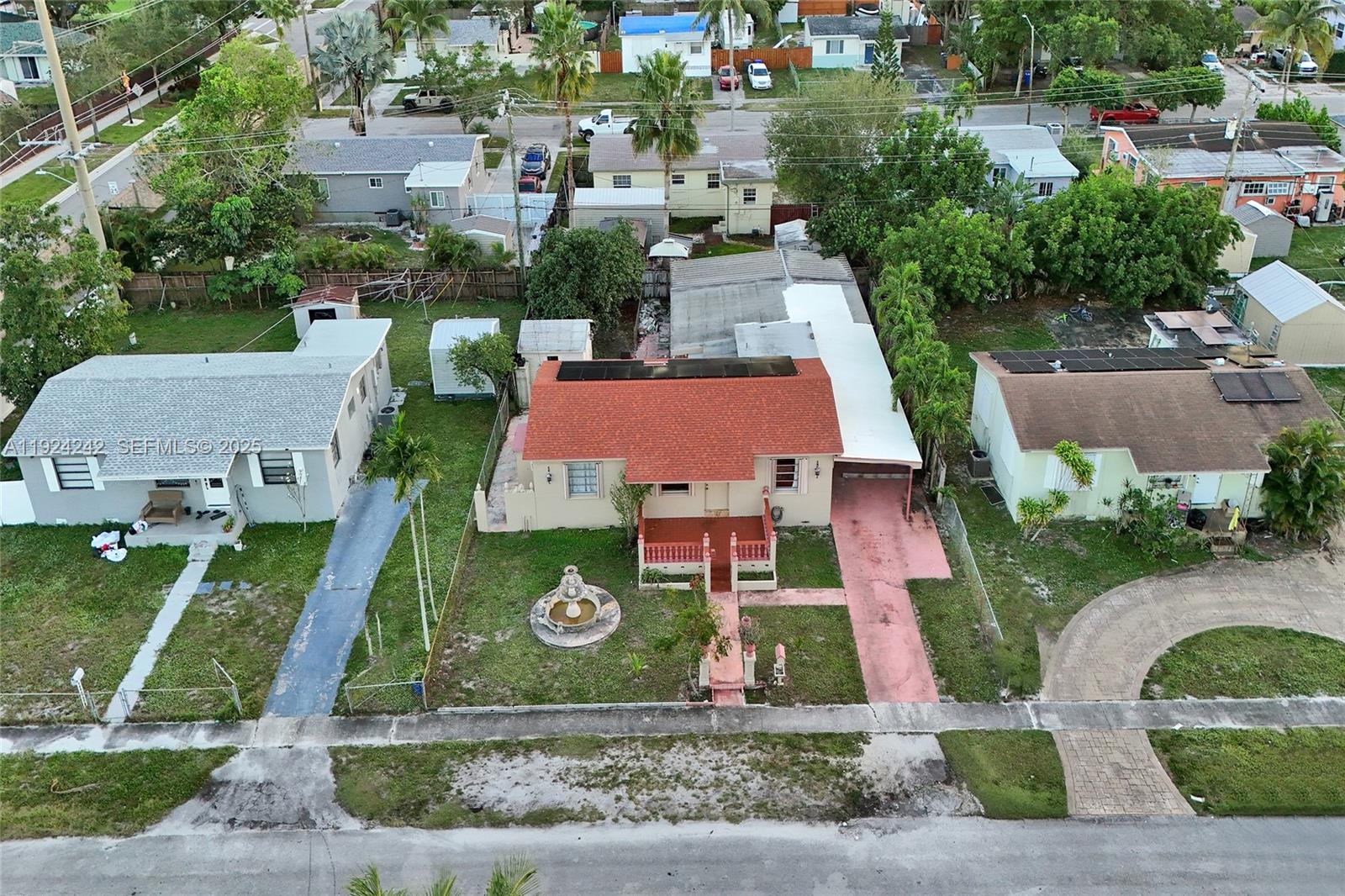 An aerial view shows a house with a red roof, a fountain, and a driveway — 6404 Evans St, Hollywood FL 33024, HOLLYWOOD, FL
