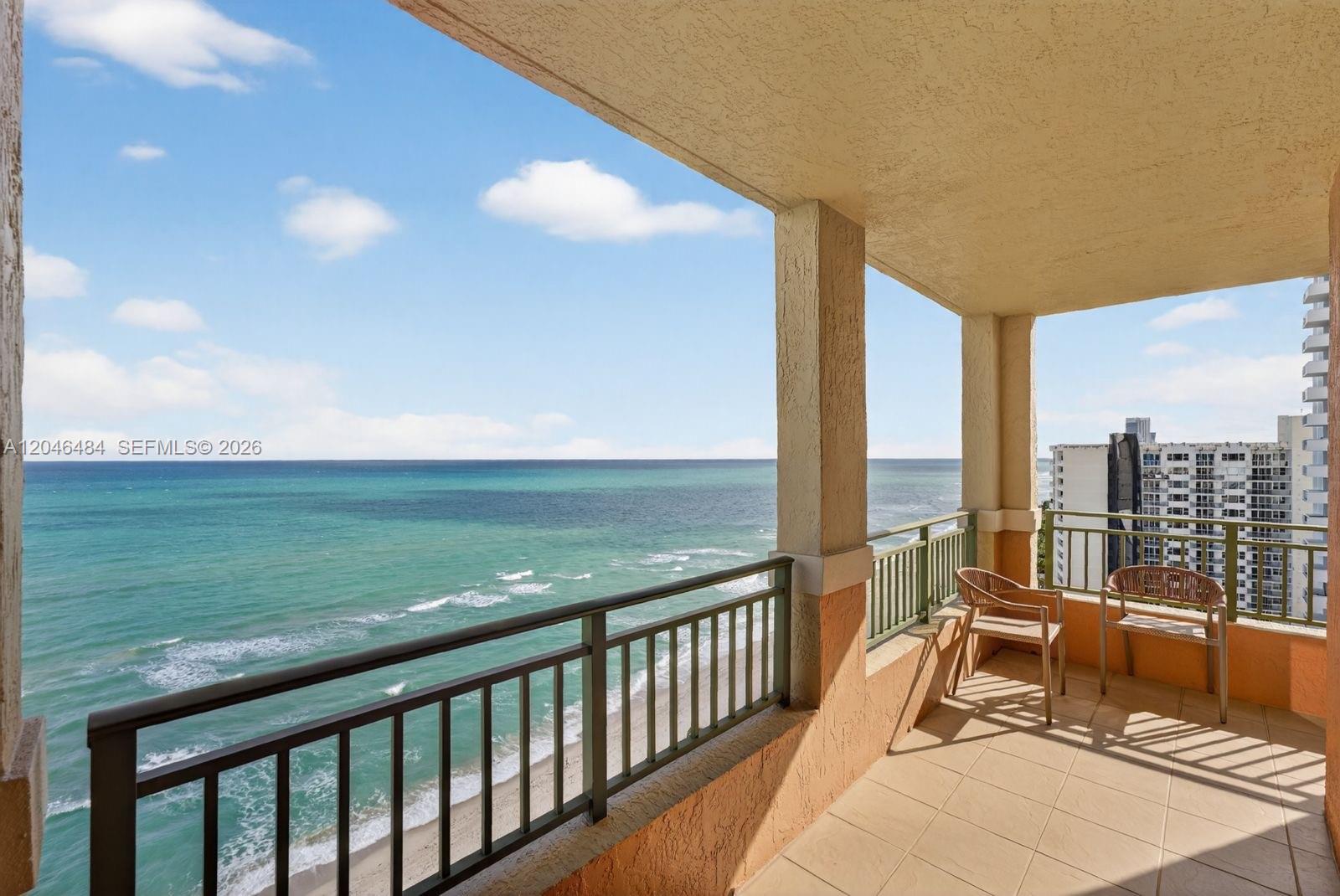 A covered balcony features a tiled floor, metal railings, and an expansive ocean view — 2080 S Ocean Dr # 1711, Hallandale Beach FL 33009, HALLANDALE BEACH, FL
