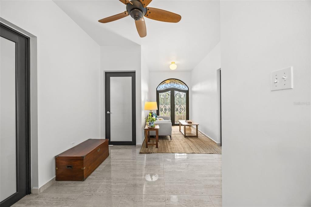 A bright entryway with tiled floors, a wooden chest, and a view of a living area — PR 466 ACUAMARINA UNIT KM 4.9, ISABELA, PR