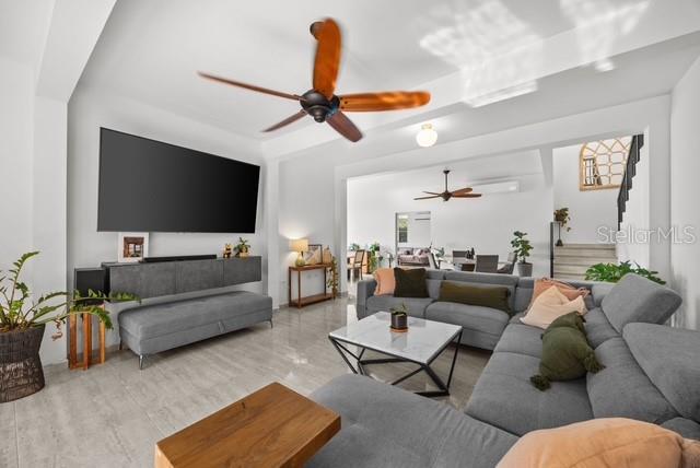A modern living room features a large sectional sofa, a wall-mounted television, and ceiling fans — PR 466 ACUAMARINA UNIT KM 4.9, ISABELA, PR