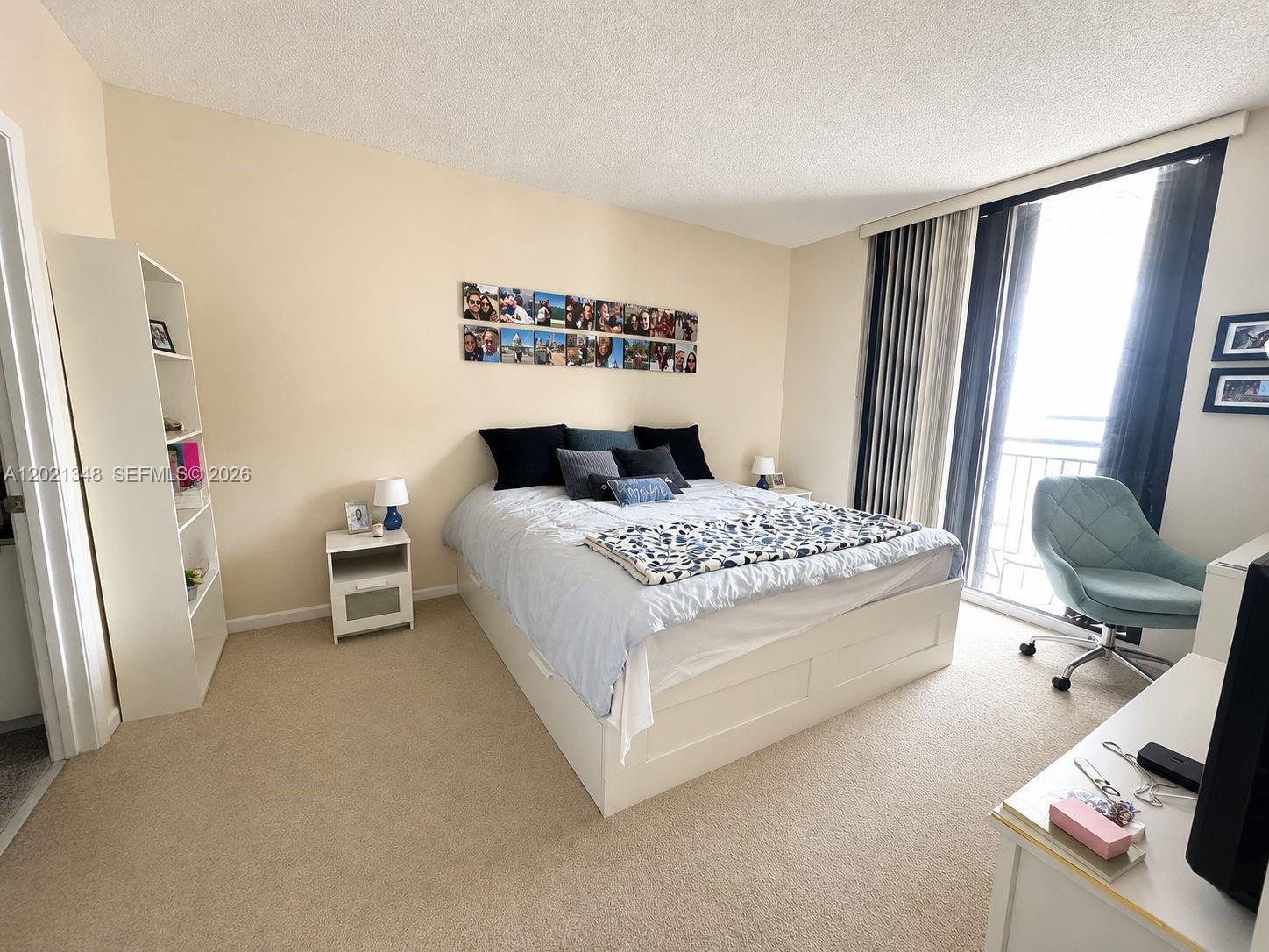 A bedroom features a bed with a white frame, a bookshelf, and a desk chair — 540 Brickell Key Dr # 1801, Miami FL 33131, MIAMI, FL