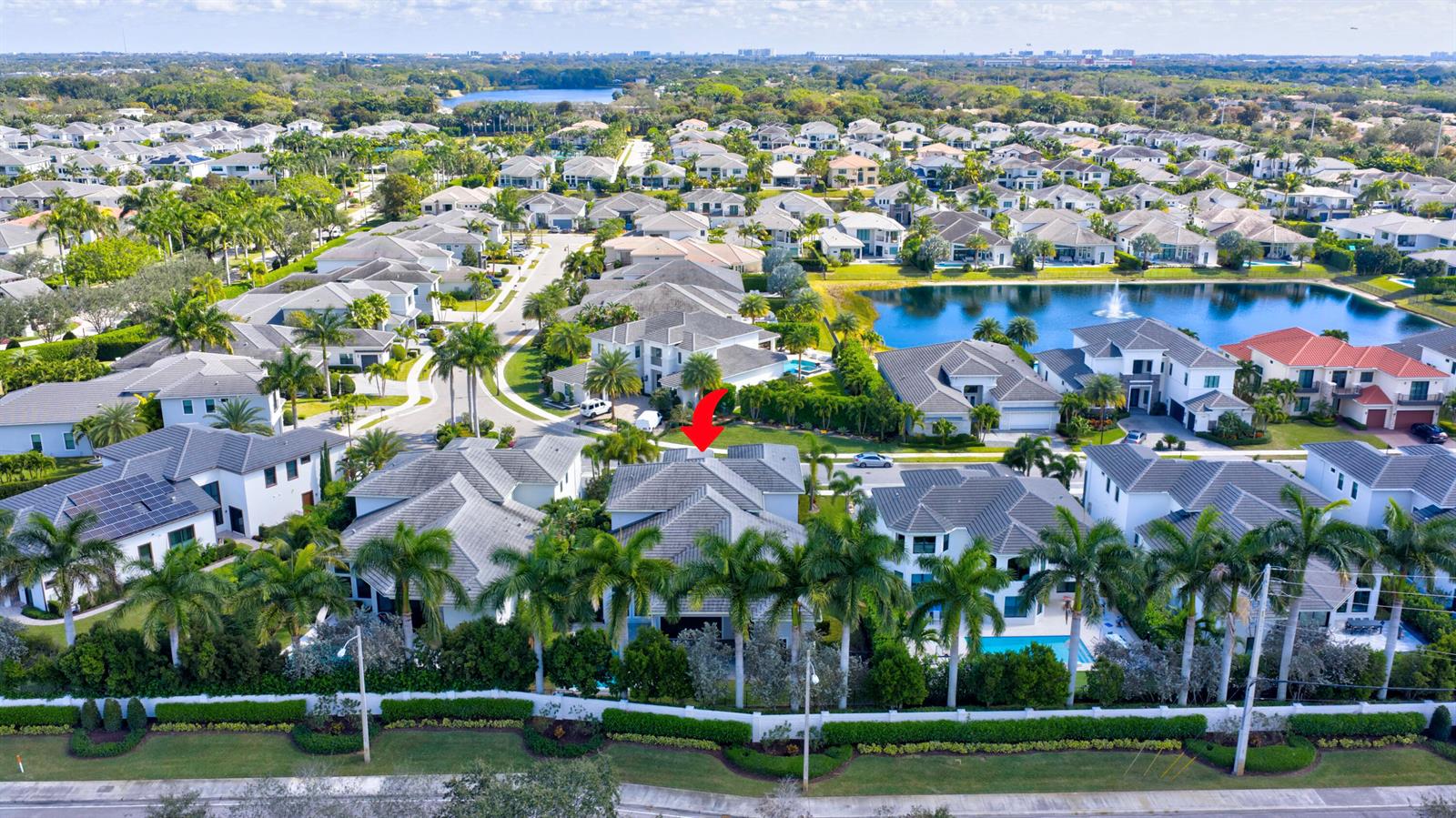 An aerial view shows a residential neighborhood with houses, palm trees, and a central pond — 6980 NW 28th Avenue, Boca Raton FL 33496, BOCA RATON, FL