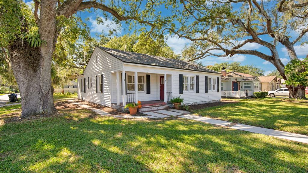 A white, single-story house with a covered front porch sits on a grassy lawn — 2 W YALE STREET, ORLANDO, FL