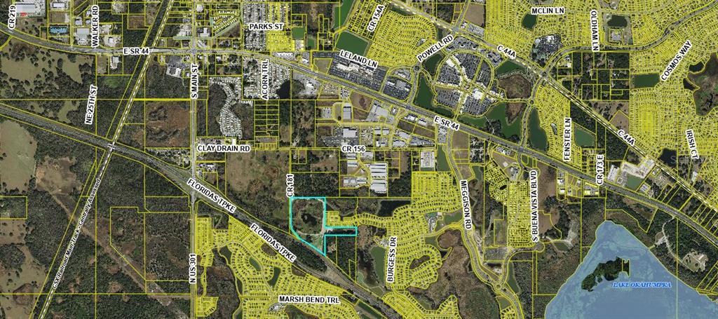 An aerial map view showing a highlighted property parcel near a highway and residential areas — 4102 COUNTY ROAD 181, WILDWOOD, FL