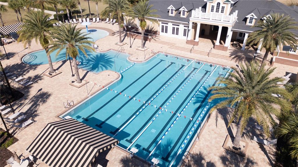 An aerial view shows a community swimming pool with lap lanes and a separate wading area — 11943B SW 31ST ROAD, GAINESVILLE, FL