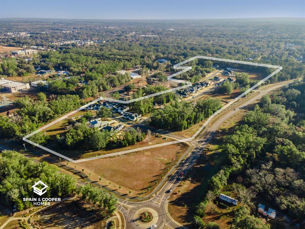 An aerial view shows a residential development outlined in white, situated near a road roundabout — 761 SW 139TH COURT, NEWBERRY, FL