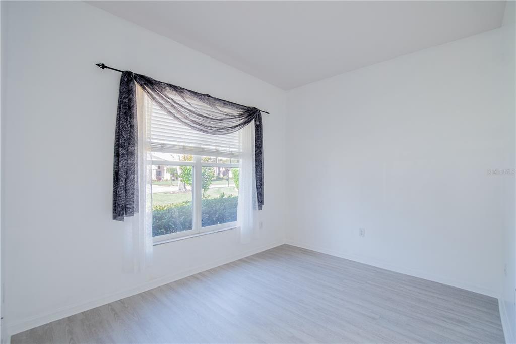 A bedroom with a king bed, two armchairs, a dresser, and a ceiling fan — 4810 WATER LARK WAY, VALRICO, FL