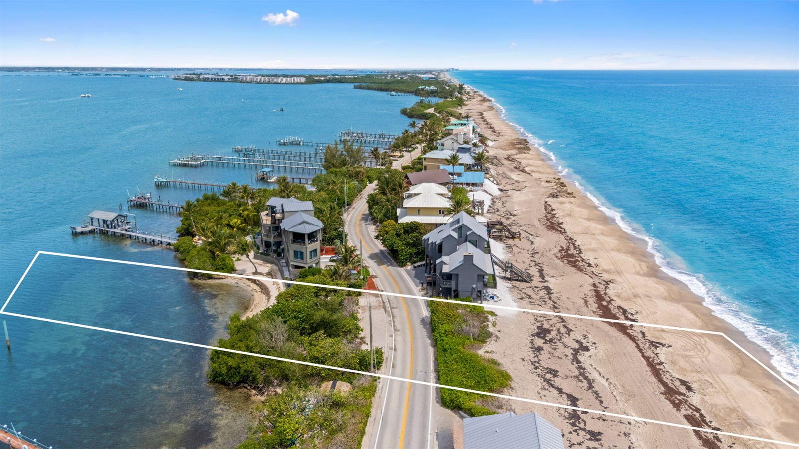 An aerial view shows a coastal property lot spanning from the bay to the ocean — 918 SE Macarthur Boulevard, Stuart FL 34996, STUART, FL