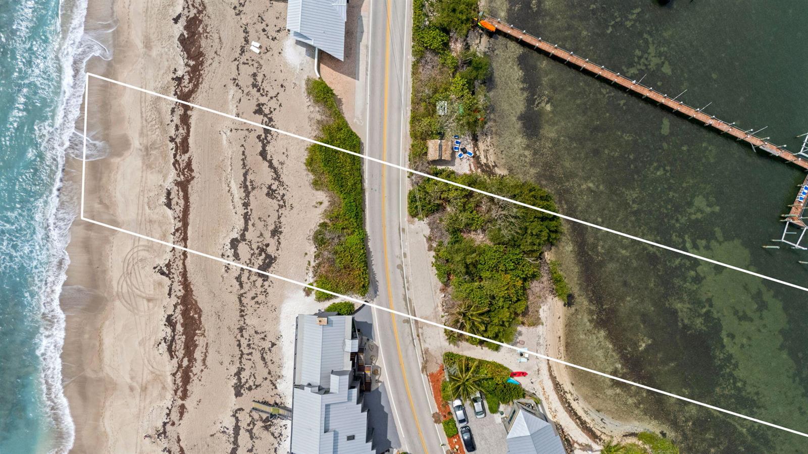 An aerial view shows a coastal property lot extending from the ocean to the bay — 918 SE Macarthur Boulevard, Stuart FL 34996, STUART, FL