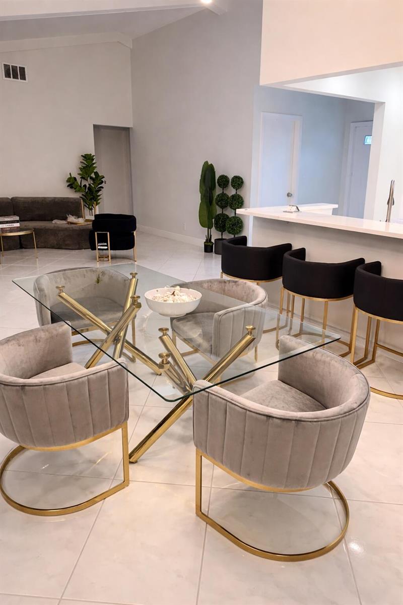 A dining area with a glass-top table, velvet chairs, and bar stools on tile floors — 9940 Liberty Road, Boca Raton FL 33434, BOCA RATON, FL