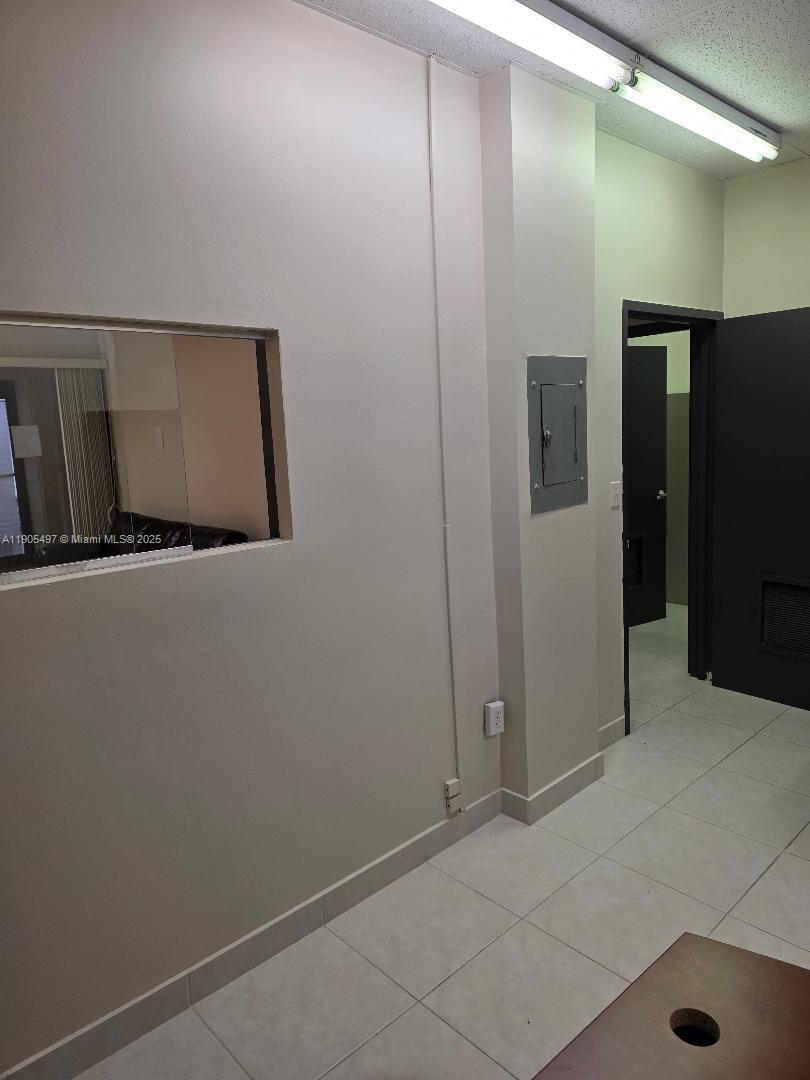This interior view shows a room with beige walls, a window, and tiled flooring — 1985 S Ocean Dr # 3L, Hallandale Beach FL 33009, HALLANDALE BEACH, FL