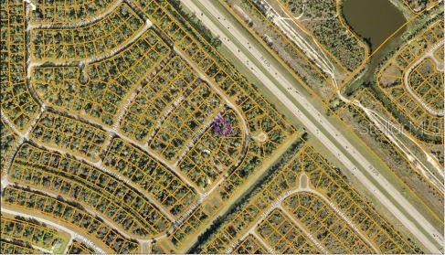 This is an aerial map showing a residential neighborhood with a highlighted property lot — MARSDEN AVENUE, NORTH PORT, FL