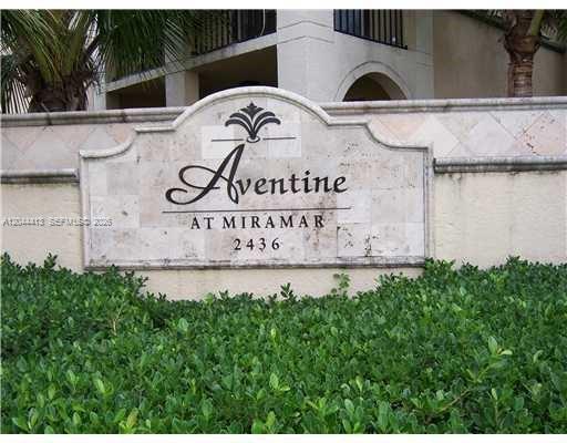 A stone monument sign for Aventine at Miramar stands in front of a building and bushes — 2464 Centergate Dr # 101, Miramar FL 33025, MIRAMAR, FL