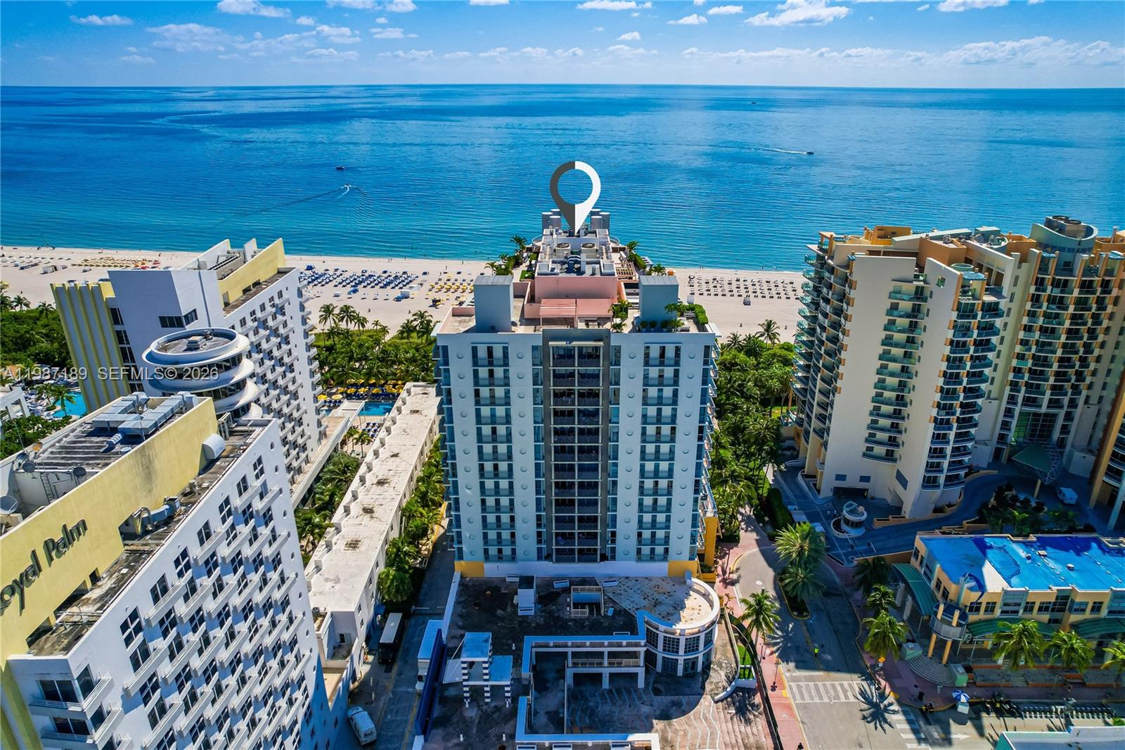 An aerial view shows a high-rise building situated on a beach along the ocean — 1500 Ocean Dr # 505, Miami Beach FL 33139, MIAMI BEACH, FL