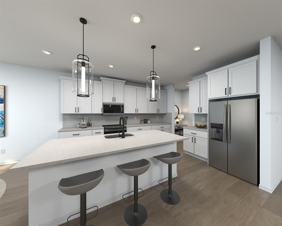 This is a rendering of a modern kitchen featuring white cabinets, an island, and stainless appliances — 14176 HARVEST PINES LANE, HUDSON, FL