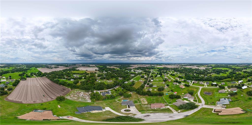 An aerial view shows a rural residential neighborhood with houses, large lawns, and tilled fields — 1318 LITTLE ALAFIA DRIVE, PLANT CITY, FL