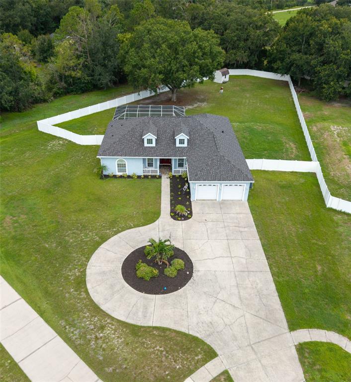 An aerial view shows a single-story house with a pool enclosure and a circular driveway — 1318 LITTLE ALAFIA DRIVE, PLANT CITY, FL