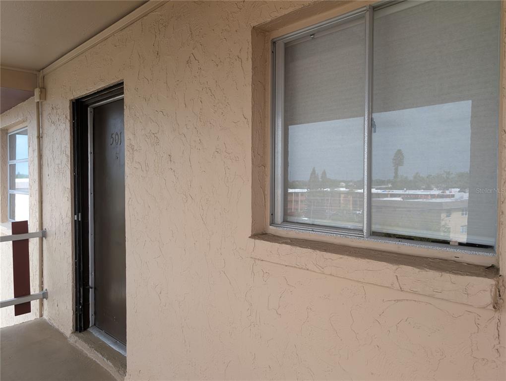 A view of an apartment building exterior hallway with a door labeled 501 and window — 4129 LAKE BAYSHORE DRIVE UNIT C-501, BRADENTON, FL