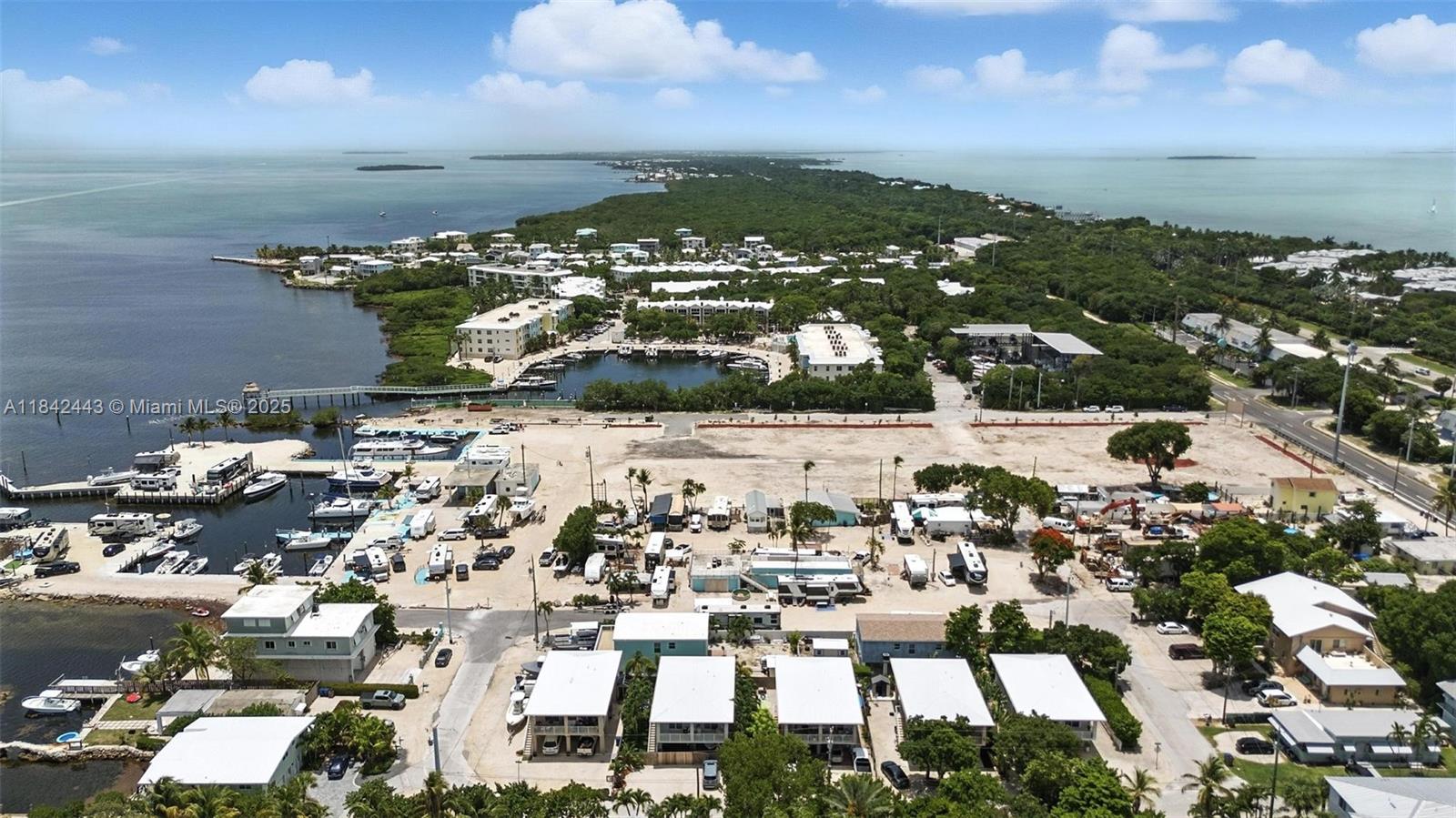 An aerial view shows a coastal property with a marina, RV park, and residential buildings — 97601 Overseas Hwy, Key Largo FL 33037, KEY LARGO, FL
