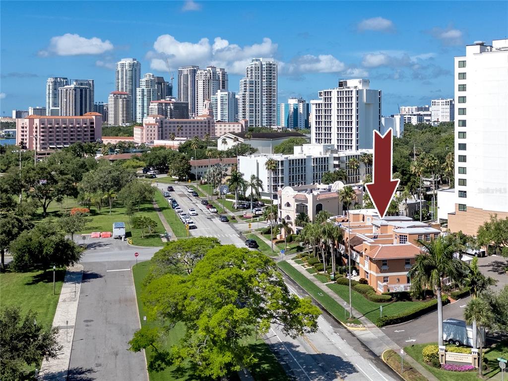 An aerial view shows a multi-story residential building with a red arrow pointing toward it — 920 NORTH SHORE DRIVE NE, ST PETERSBURG, FL