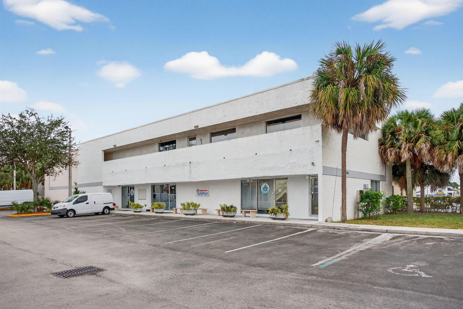 A two-story white commercial building with a parking lot and palm trees in front — 2800 N State 7 Road, Margate FL 33063, MARGATE, FL