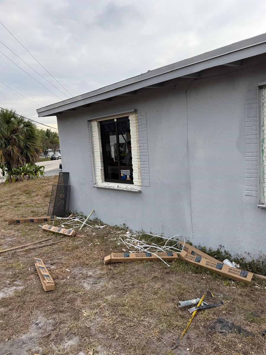The exterior of a house shows a newly installed window with surrounding construction debris — 1501 NW 3rd Way, Pompano Beach FL 33060, POMPANO BEACH, FL