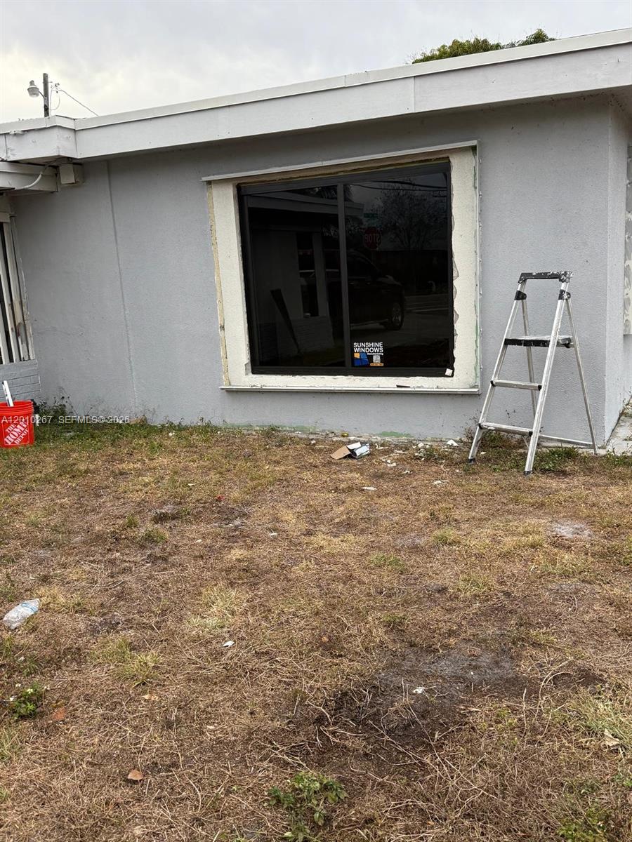 A newly installed window with unfinished trim sits on the exterior wall of a house — 1501 NW 3rd Way, Pompano Beach FL 33060, POMPANO BEACH, FL
