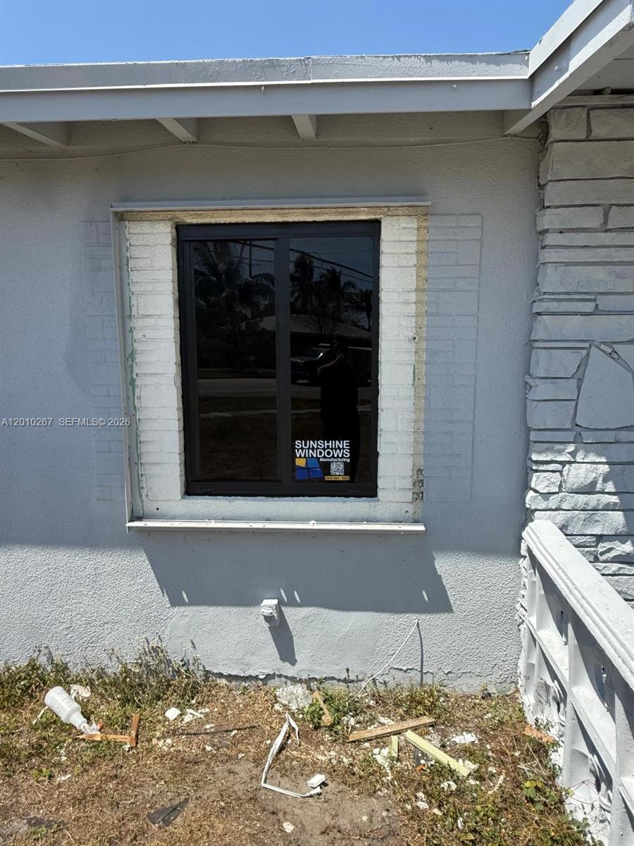 A newly installed window with an unfinished exterior frame sits in a stucco wall — 1501 NW 3rd Way, Pompano Beach FL 33060, POMPANO BEACH, FL