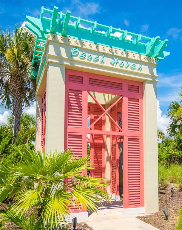A pink and cream outdoor pavilion with a turquoise pergola stands amidst palm trees — 46 HIDDEN TREASURE DRIVE, PALM COAST, FL