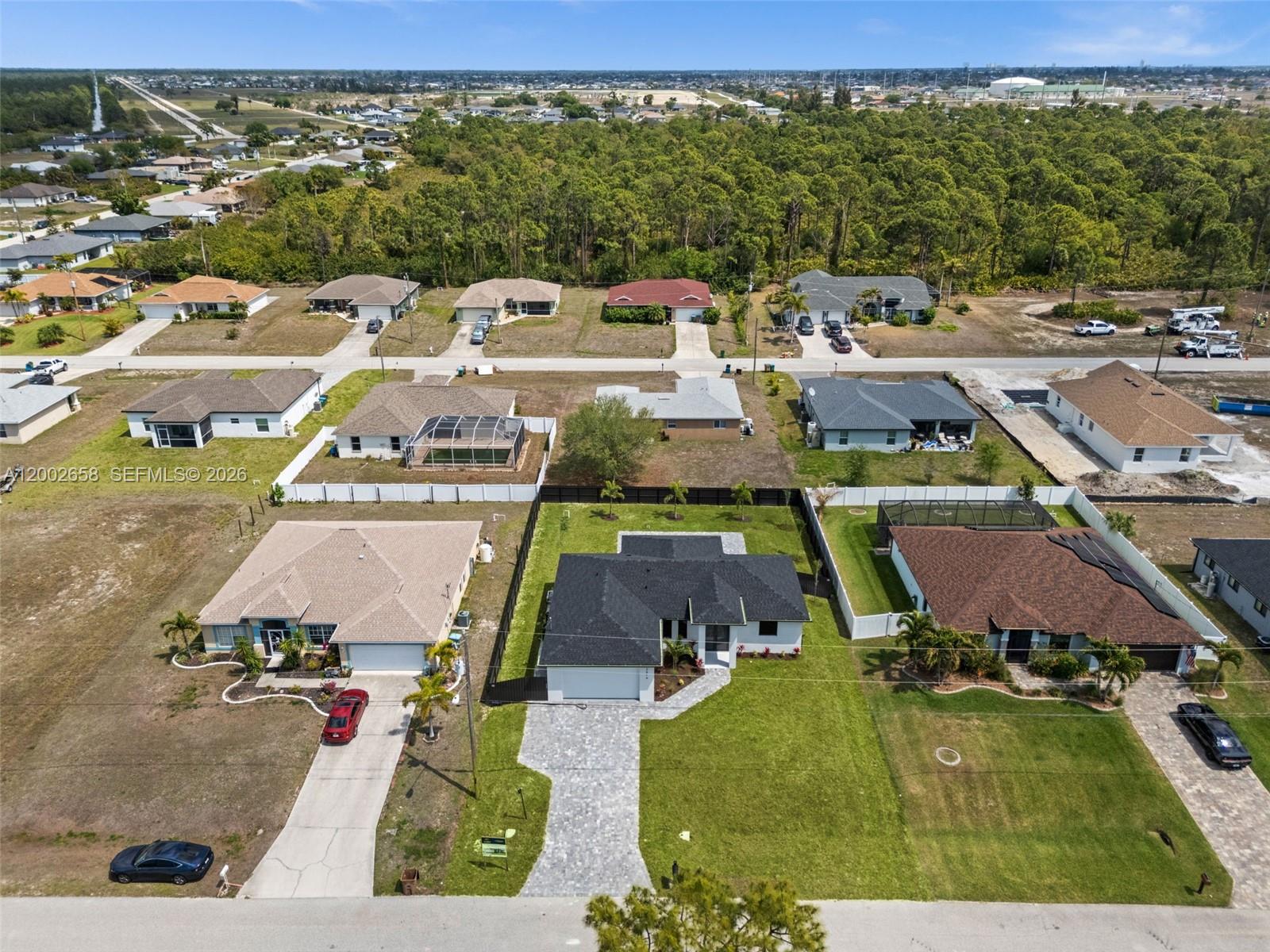 An aerial view shows several suburban houses with driveways and lawns in a residential neighborhood — 2519 NW 18TH, Cape Coral FL 33993, CAPE CORAL, FL