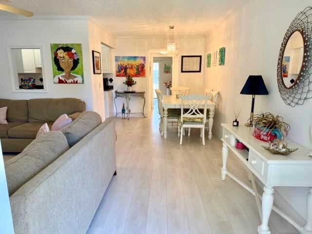 A living room and dining area with light wood flooring and white walls — 635 Durham W, Deerfield Beach FL 33442, DEERFIELD BEACH, FL