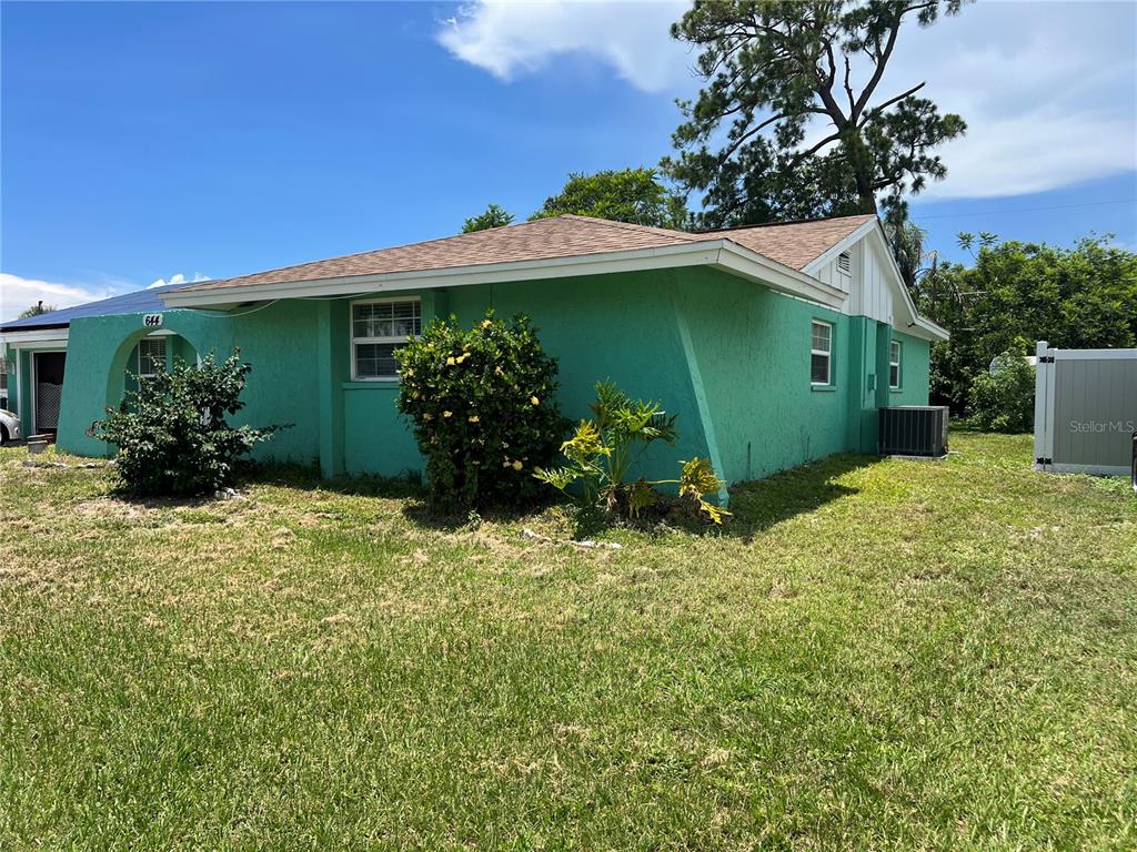 A green, single-story house with a hip roof and a small front porch — 644 ERROLL STREET, PORT CHARLOTTE, FL