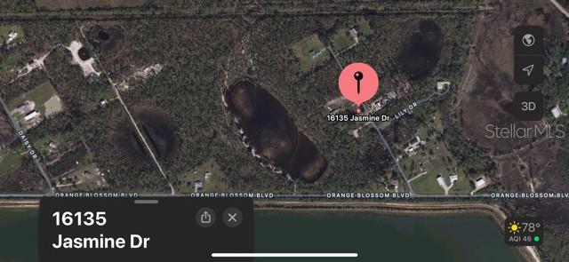 This is a satellite map view showing a residential property location near a large lake — 16135 JASMINE DRIVE, PUNTA GORDA, FL