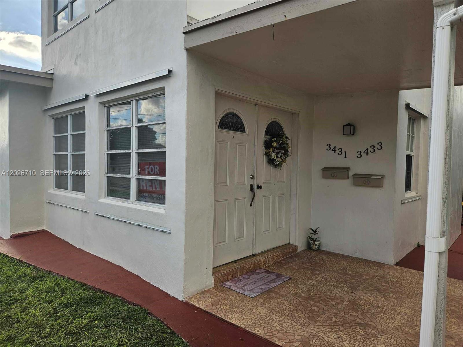 The exterior of a white building features a double front door and two mailboxes — 3431 SW 4th St # 1, Miami FL 33135, MIAMI, FL