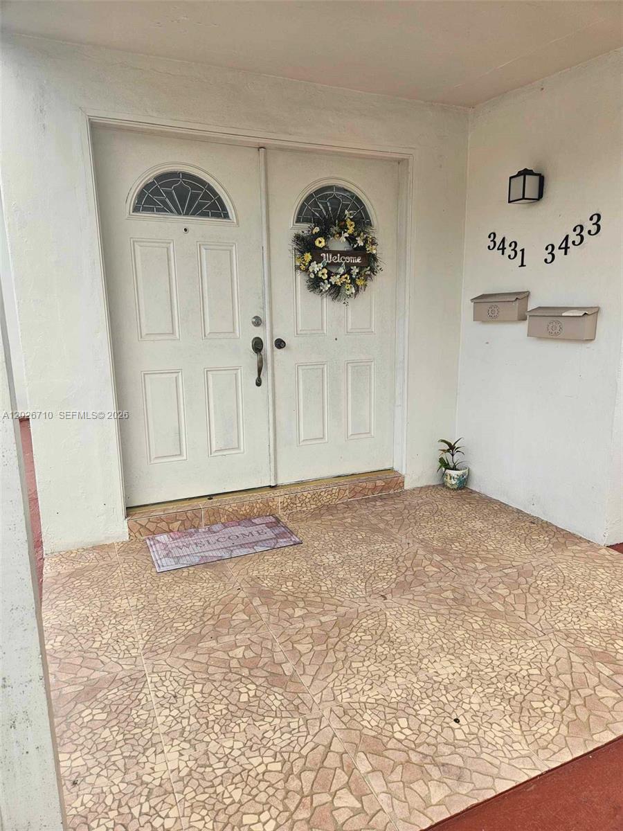 A double front door with a wreath and two mailboxes sits on a tiled porch — 3431 SW 4th St # 1, Miami FL 33135, MIAMI, FL