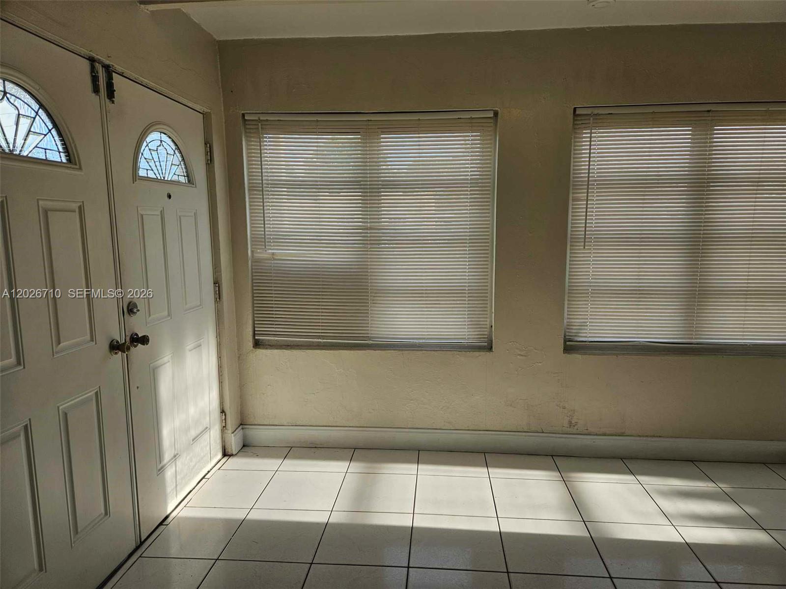 A room with white tiled floors, a white door with glass inserts, and two windows — 3431 SW 4th St # 1, Miami FL 33135, MIAMI, FL