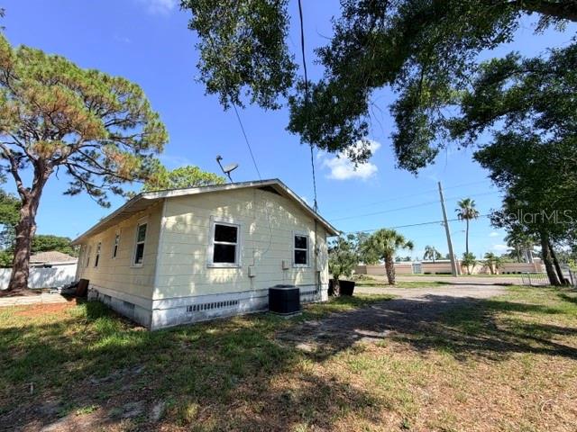 The exterior of a light yellow house with a satellite dish and central air unit — 420 53RD AVENUE E, BRADENTON, FL