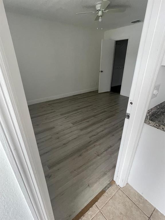 A two-story building exterior features a ground-level patio and an upper-level balcony with white railings — 1069 S HIAWASSEE ROAD UNIT 1322, ORLANDO, FL