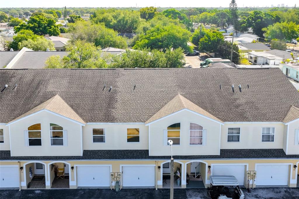 An aerial view shows the roof and front facade of a multi-unit townhouse complex — 6400 46TH AVENUE N UNIT 71, KENNETH CITY, FL