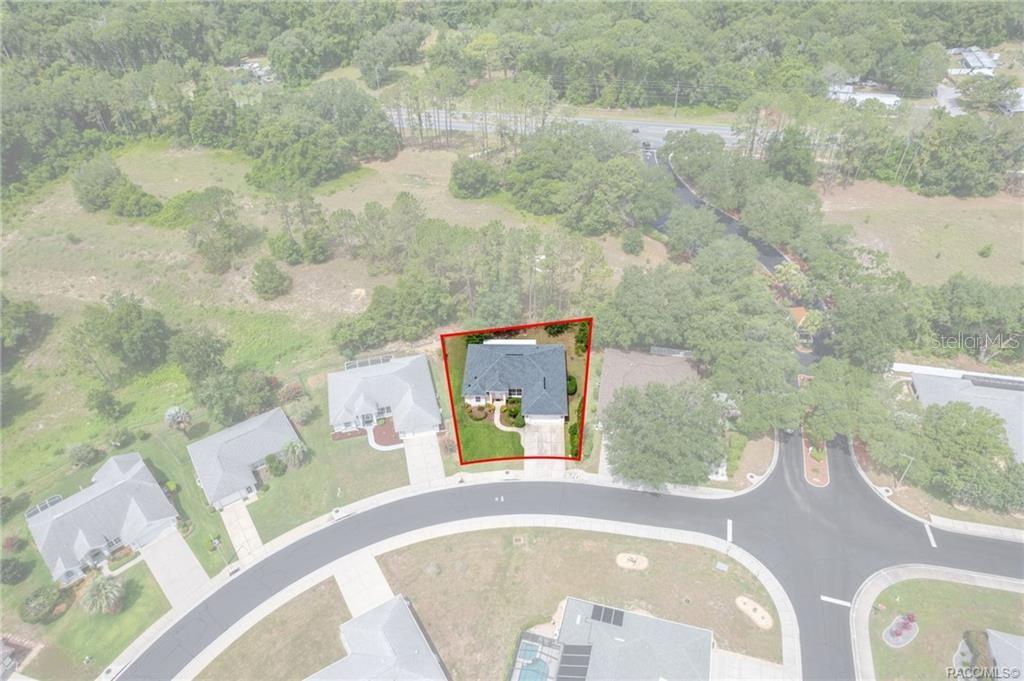 An aerial view shows a single-family house with a red outline on a suburban lot — 3556 E COVE PARK TRAIL, HERNANDO, FL