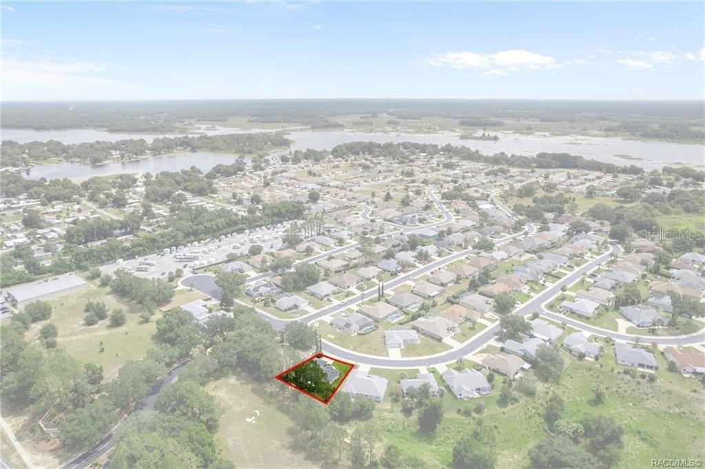 An aerial view shows a residential property highlighted in red within a suburban neighborhood — 3556 E COVE PARK TRAIL, HERNANDO, FL