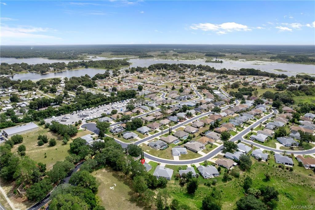 Aerial view of a residential neighborhood with a red marker on a specific house — 3556 E COVE PARK TRAIL, HERNANDO, FL