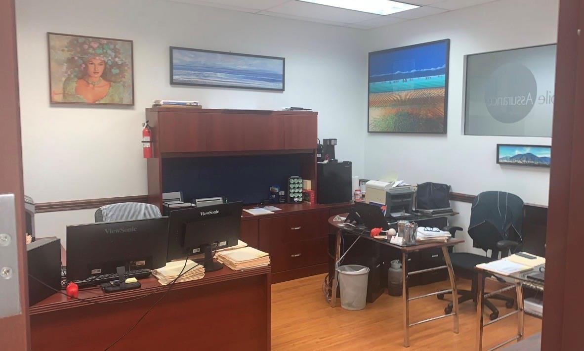 An office with two desks, wood-laminate flooring, dark wood furniture, and framed wall art — 2893 Executive Park Drive # 105, Weston FL 33331, WESTON, FL