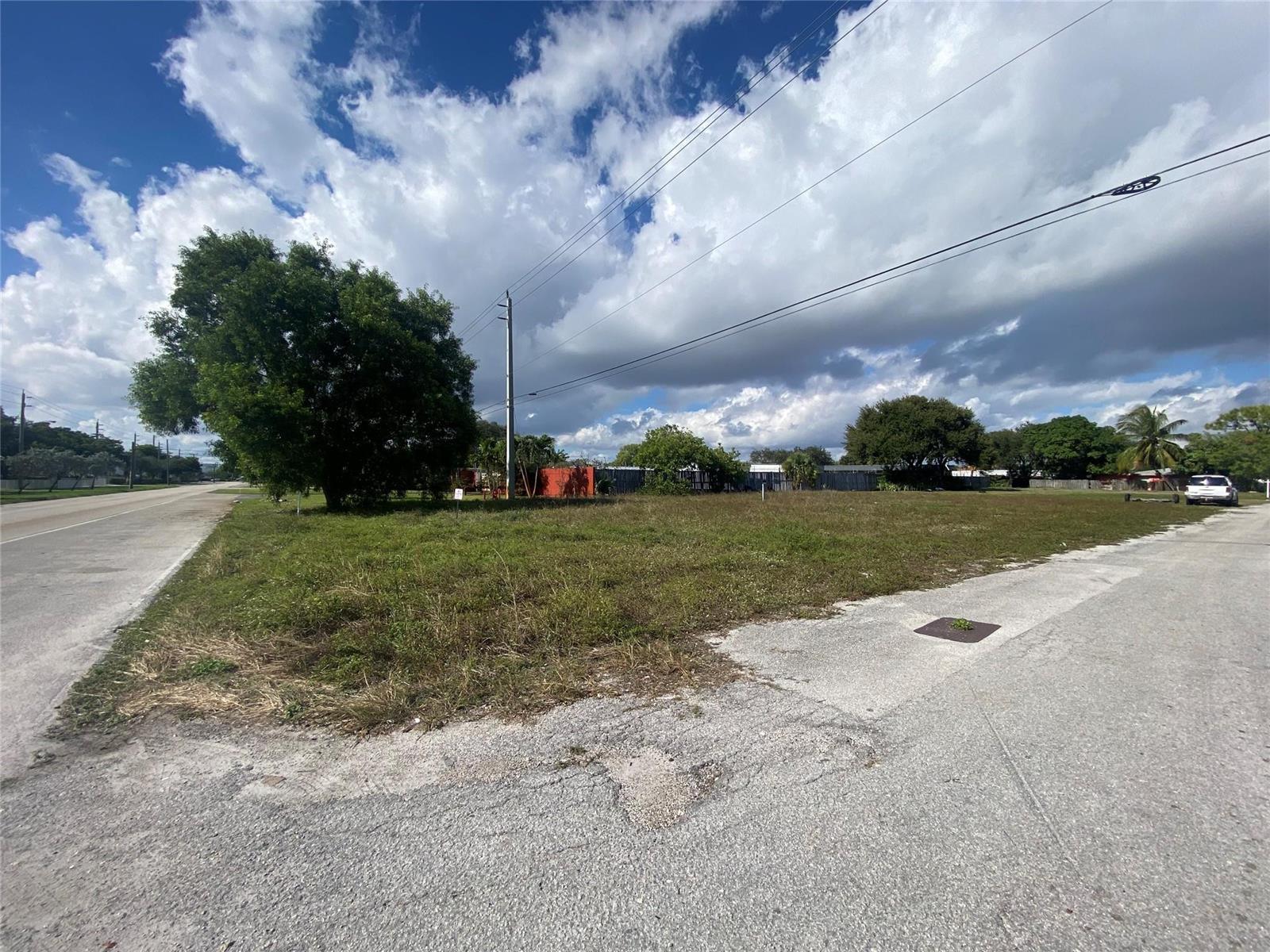 A vacant, grassy corner lot sits at the intersection of two paved roads — Nw 19 NW 19th Avenue, Pompano Beach FL 33069, POMPANO BEACH, FL