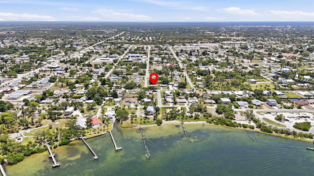 An aerial view shows a residential neighborhood along a waterfront with a red location pin — 155 MAGNOLIA AVENUE, ENGLEWOOD, FL
